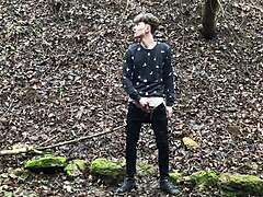 the horny cute european boy steps outdoors in snowy weather, stroking his big dick with intense focus until climax.