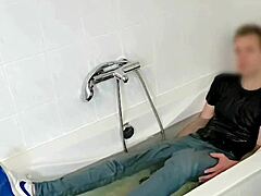 Hey, check out twink playing around in soaked jeans and kicks