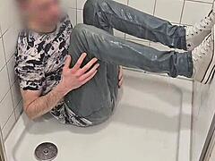 twink plays in shower jeans sneakers fully clothed wet fun